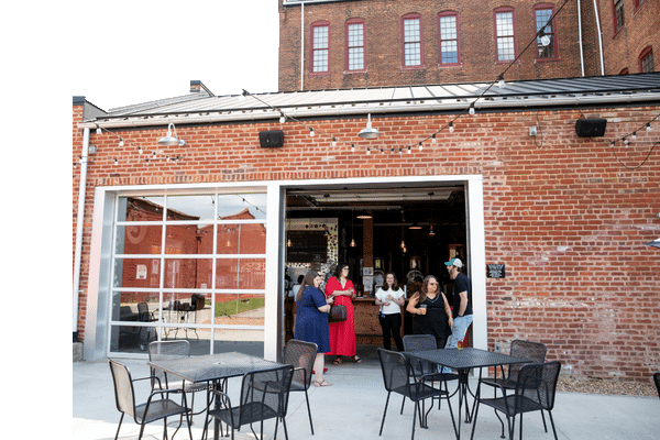 Increasing small-town tourism: A group of people enjoying a Farmville brewery.