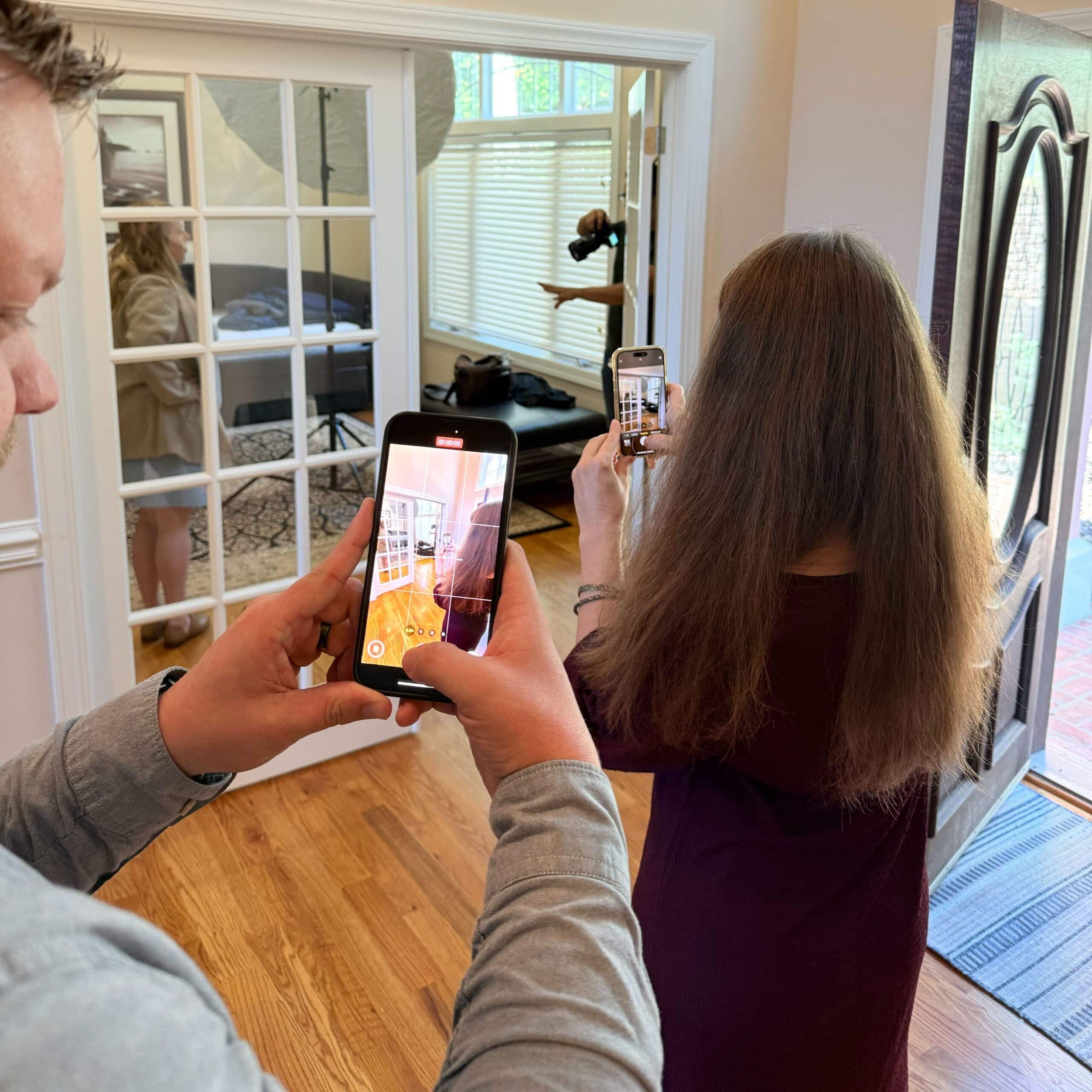 Letterpress team members document a photoshoot on their cell phones. A smartphone camera view is visible, demonstrating the photography rule of thirds. The photographer is positioning the subject in the right third of the image.