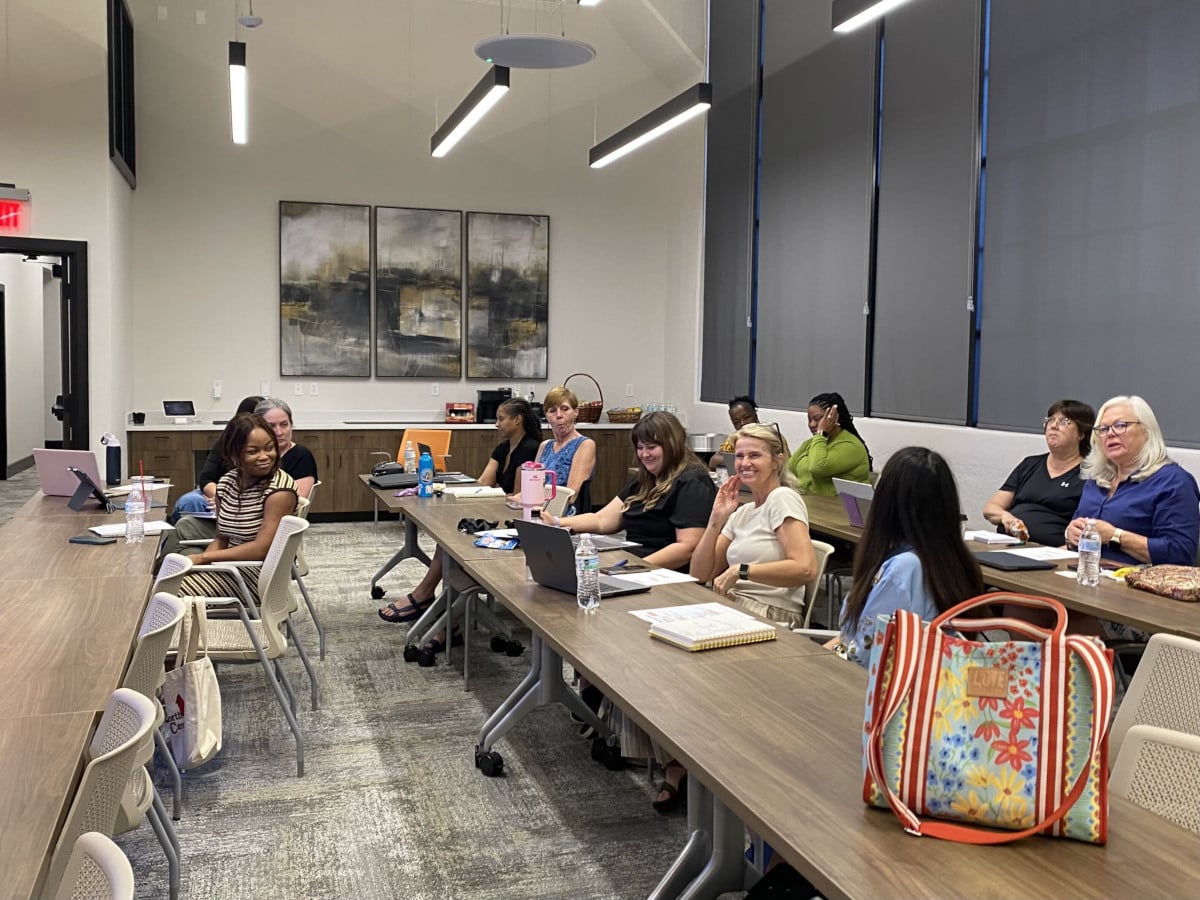 Participants sit behind desks smiling at a marketing workshop in Danville, VA